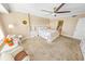 Main bedroom with king bed, seating area, and access to bathroom at 4670 Links Village Dr # C402, Ponce Inlet, FL 32127