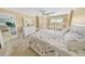 Main bedroom with king-size bed, dresser, and access to bathroom at 4670 Links Village Dr # C402, Ponce Inlet, FL 32127