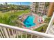 Inviting community pool with lounge chairs and umbrellas at 4670 Links Village Dr # C402, Ponce Inlet, FL 32127