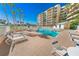 Community pool with plenty of lounge chairs at 4670 Links Village Dr # C402, Ponce Inlet, FL 32127