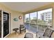 Spacious screened balcony with seating and partial ocean view at 5300 S Atlantic Ave # 13307, New Smyrna Beach, FL 32169