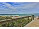 Wooden walkway to beach with ocean view at 5300 S Atlantic Ave # 13307, New Smyrna Beach, FL 32169