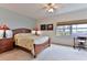 Bright bedroom with ocean view, ceiling fan, and wooden furniture at 5300 S Atlantic Ave # 13307, New Smyrna Beach, FL 32169