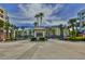 Grand gated entrance to the community with palm trees and landscaping at 5300 S Atlantic Ave # 13307, New Smyrna Beach, FL 32169