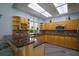 Well-equipped community kitchen with granite countertops and wood cabinets at 5300 S Atlantic Ave # 13307, New Smyrna Beach, FL 32169