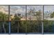 Screened in balcony with sunset views over trees and blue railing at 5300 S Atlantic Ave # 9-304, New Smyrna Beach, FL 32169