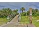 Wooden walkway leading to the beach with a shower station at 5300 S Atlantic Ave # 9-304, New Smyrna Beach, FL 32169