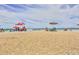Relaxing beach scene with umbrellas and calm ocean waves at 5300 S Atlantic Ave # 9-304, New Smyrna Beach, FL 32169