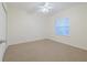 Empty bedroom with carpeted floors and a window at 5300 S Atlantic Ave # 9-304, New Smyrna Beach, FL 32169