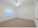 Bright bedroom with window, ceiling fan, and carpeted floors at 5300 S Atlantic Ave # 9-304, New Smyrna Beach, FL 32169