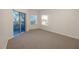 Bright bedroom with carpet flooring and sliding glass door to balcony at 5300 S Atlantic Ave # 9-304, New Smyrna Beach, FL 32169