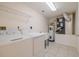 Laundry room with washer, dryer, water heater, and overhead wire shelf at 5300 S Atlantic Ave # 9-304, New Smyrna Beach, FL 32169