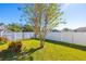 Large backyard with a white fence and green grass at 5477 Carmody Lake Dr, Port Orange, FL 32128