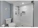 Contemporary bathroom with a walk-in shower with textured tile and a pebble floor at 5499 S Atlantic Ave # 905, New Smyrna Beach, FL 32169