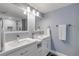 Modern bathroom with double vanities, a walk-in shower, and updated fixtures at 5499 S Atlantic Ave # 905, New Smyrna Beach, FL 32169