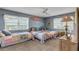 Coastal-themed bedroom with two twin beds, surf decor, and ocean views at 5499 S Atlantic Ave # 905, New Smyrna Beach, FL 32169