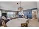 Open concept dining area with white table, ocean view, and access to balcony at 5499 S Atlantic Ave # 905, New Smyrna Beach, FL 32169