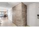 Entryway with white door, wood-look tile, and view of the living room at 5499 S Atlantic Ave # 905, New Smyrna Beach, FL 32169
