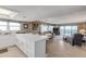 White kitchen with island, stainless steel appliances, and open to living area at 5499 S Atlantic Ave # 905, New Smyrna Beach, FL 32169