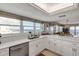 Updated kitchen featuring white cabinetry, stainless steel appliances, and ocean views at 5499 S Atlantic Ave # 905, New Smyrna Beach, FL 32169