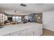 Modern kitchen with white cabinets, quartz countertops, and ocean views from the adjacent living area at 5499 S Atlantic Ave # 905, New Smyrna Beach, FL 32169