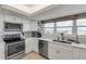 Modern white kitchen with stainless steel appliances and ample counter space at 5499 S Atlantic Ave # 905, New Smyrna Beach, FL 32169