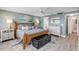 Coastal-themed main bedroom featuring a wooden bed frame, ocean views, and a seating area at 5499 S Atlantic Ave # 905, New Smyrna Beach, FL 32169