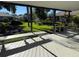 Covered patio with wooden deck and bench overlooking a spacious backyard at 628 Middlebury Loop, New Smyrna Beach, FL 32168