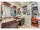 Double vanity bathroom with granite countertops and dark wood cabinets at 6307 Palmas Bay Cir, Port Orange, FL 32127