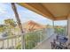 Relaxing balcony with two brown chairs and ocean view at 701 N Atlantic Ave # 203, New Smyrna Beach, FL 32169