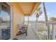 Private balcony with two brown chairs and ocean view at 701 N Atlantic Ave # 203, New Smyrna Beach, FL 32169