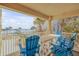 Ocean view balcony with blue chairs and a white table at 701 N Atlantic Ave # 203, New Smyrna Beach, FL 32169