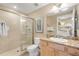 Bathroom includes a shower, toilet, granite vanity, and a mirror at 701 N Atlantic Ave # 203, New Smyrna Beach, FL 32169