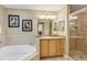 Bathroom features a corner jacuzzi tub, granite vanity, and glass-enclosed shower at 701 N Atlantic Ave # 203, New Smyrna Beach, FL 32169