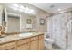 Updated bathroom with granite countertop, light wood cabinets, and a shower/tub combo at 701 N Atlantic Ave # 203, New Smyrna Beach, FL 32169