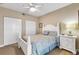 Guest bedroom with white shutter bed, ceiling fan and plenty of closet space at 701 N Atlantic Ave # 203, New Smyrna Beach, FL 32169
