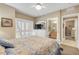 Bedroom with white shutter bed, ensuite bathroom, and private access at 701 N Atlantic Ave # 203, New Smyrna Beach, FL 32169