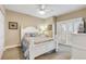 Guest bedroom with white shutter bed, ceiling fan, and access to balcony at 701 N Atlantic Ave # 203, New Smyrna Beach, FL 32169