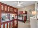 Bedroom with bunk beds, ceiling fan, and access to balcony at 701 N Atlantic Ave # 203, New Smyrna Beach, FL 32169