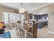Bright dining area with a farmhouse table and chairs, and a chandelier at 701 N Atlantic Ave # 203, New Smyrna Beach, FL 32169