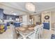 Elegant dining area with a large table and chandelier, near the kitchen at 701 N Atlantic Ave # 203, New Smyrna Beach, FL 32169