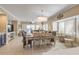 Open concept dining area with a rustic farmhouse table and chandelier at 701 N Atlantic Ave # 203, New Smyrna Beach, FL 32169