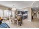 Bright dining area with a farmhouse table and chairs, and a chandelier at 701 N Atlantic Ave # 203, New Smyrna Beach, FL 32169