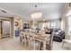 Open concept dining area with a rustic farmhouse table and chandelier at 701 N Atlantic Ave # 203, New Smyrna Beach, FL 32169