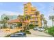 Building entrance with covered parking and landscaping at 701 N Atlantic Ave # 203, New Smyrna Beach, FL 32169