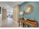 Entryway with view into living room, decorative table and mirror at 701 N Atlantic Ave # 203, New Smyrna Beach, FL 32169