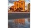 Beachfront condo building with ocean views and sunrise reflection at 701 N Atlantic Ave # 203, New Smyrna Beach, FL 32169