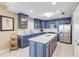 Modern kitchen with blue cabinets, white countertops, and stainless steel appliances at 701 N Atlantic Ave # 203, New Smyrna Beach, FL 32169