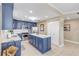 Modern kitchen with blue cabinets, white countertops, and stainless steel appliances at 701 N Atlantic Ave # 203, New Smyrna Beach, FL 32169