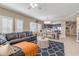 Open living room with leather sectional sofa and a view into dining area at 701 N Atlantic Ave # 203, New Smyrna Beach, FL 32169
